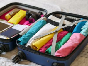 Different clothes of colors ready in the suitcase
